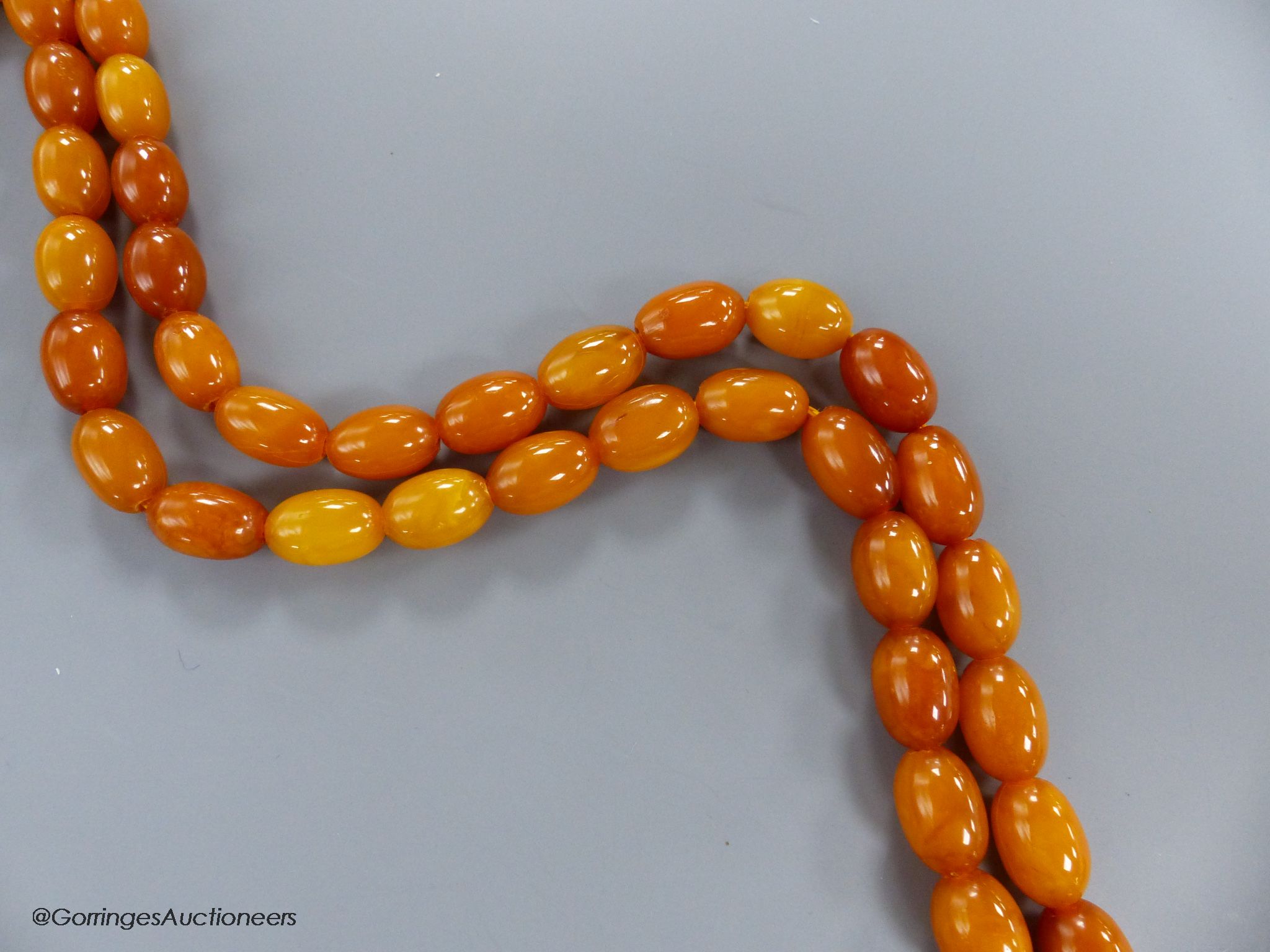 A singe strand oval amber bead necklace, 82cm, gross 45 grams.